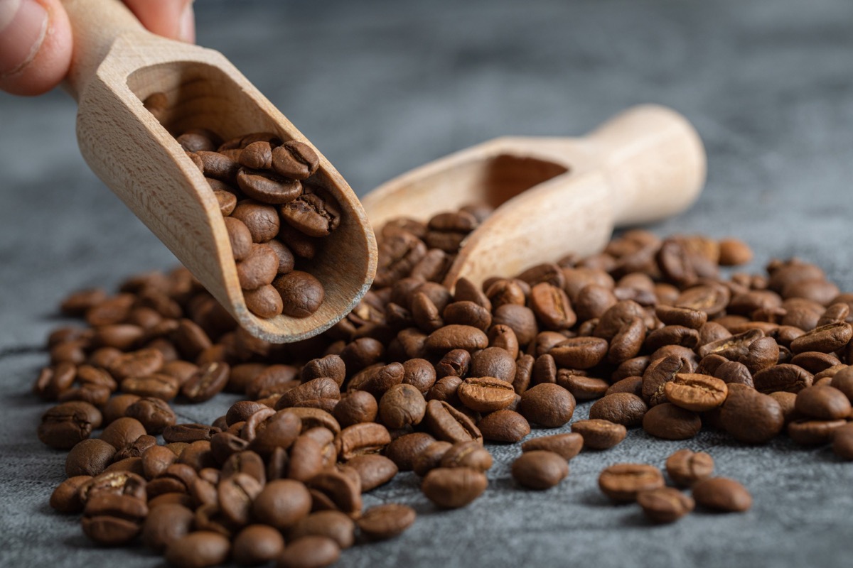 Raw unroasted green Arabica coffee beans in a burlap sack