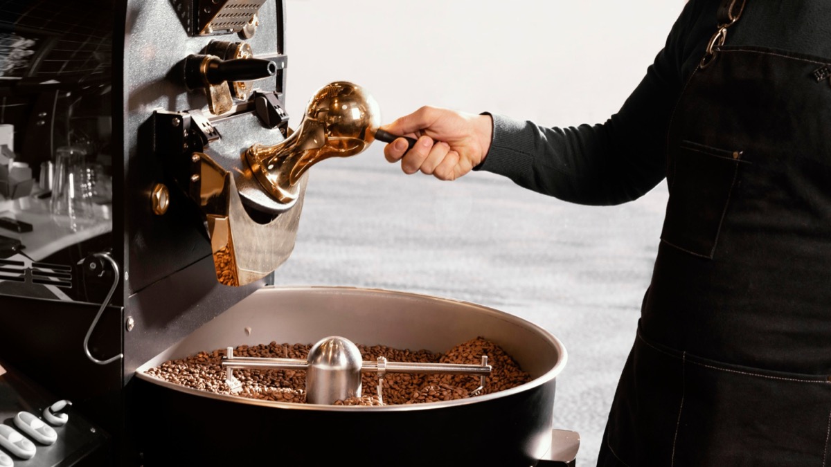 Natural process coffee beans in a drum roaster with even colour and strong aroma