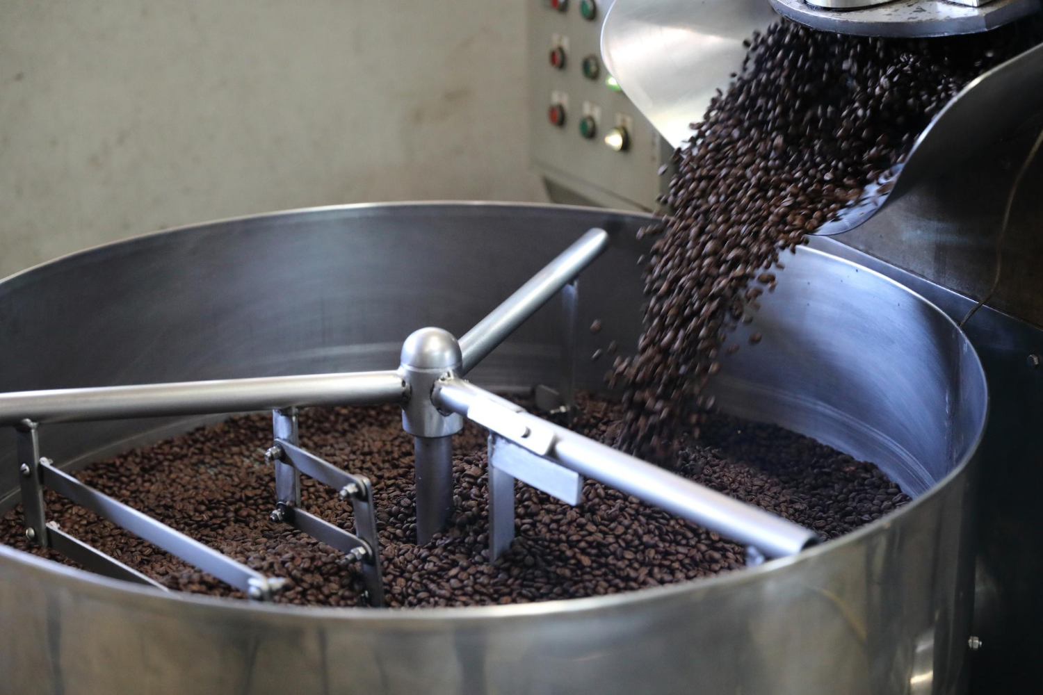 Honey process coffee beans in a roaster showing even caramelization and color